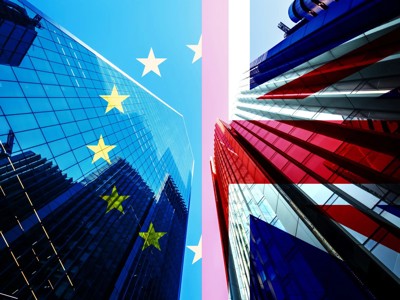 Skyscraper Reflected On EU And UK Flags