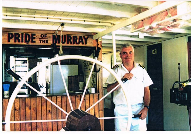 Anthony Brown holding ship steering wheel