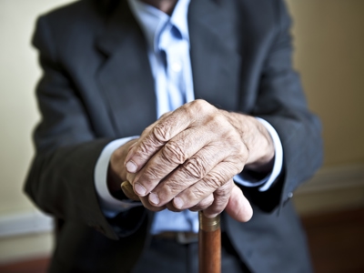 Anonymous Elderly Man Holding Stick