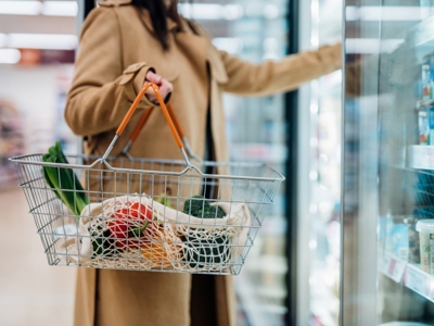 Woman In Supermarket With Shopping Basket Resized