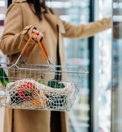 Woman In Supermarket With Shopping Basket Resized