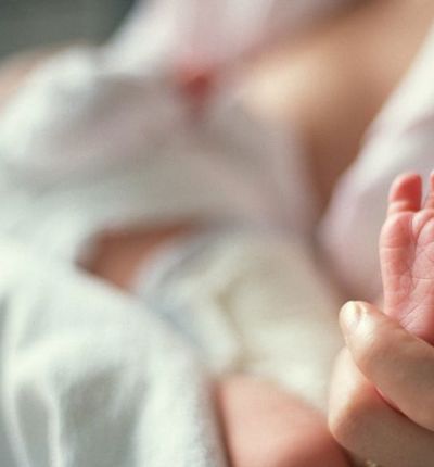 Mother Holding Newborn Foot