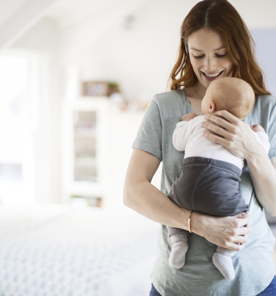 Mom smiling and holding her baby