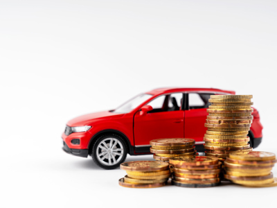 Red Car And Stack Of Coins On White Background