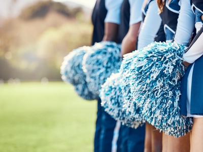 Cheerleaders With Blue And White Pom Poms