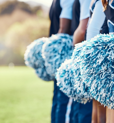 Cheerleaders With Blue And White Pom Poms