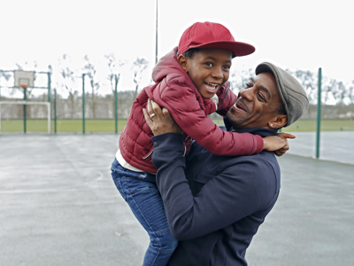 Father and son playing in park